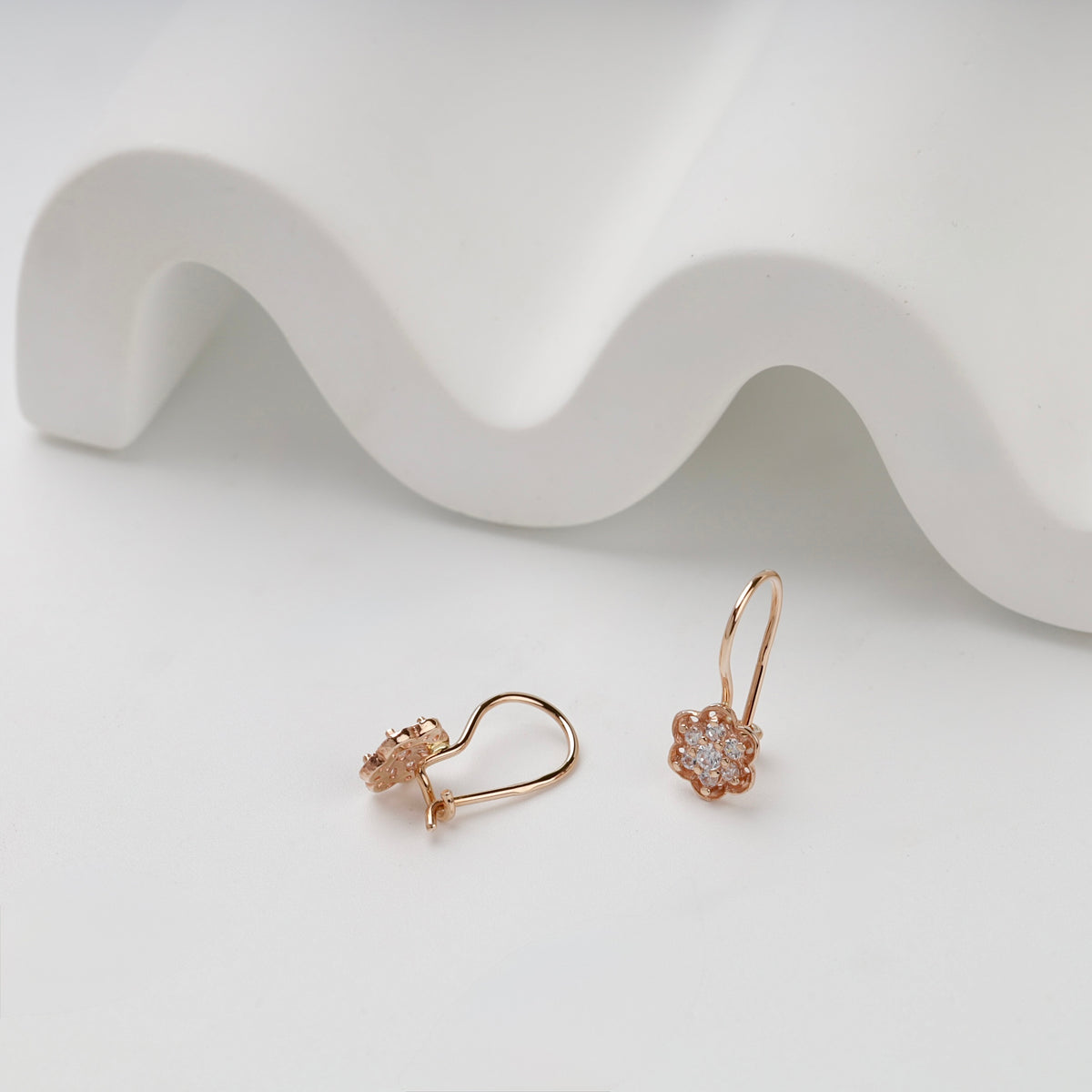 Rose Gold flower kids earrings showing hook fastenings and open backs