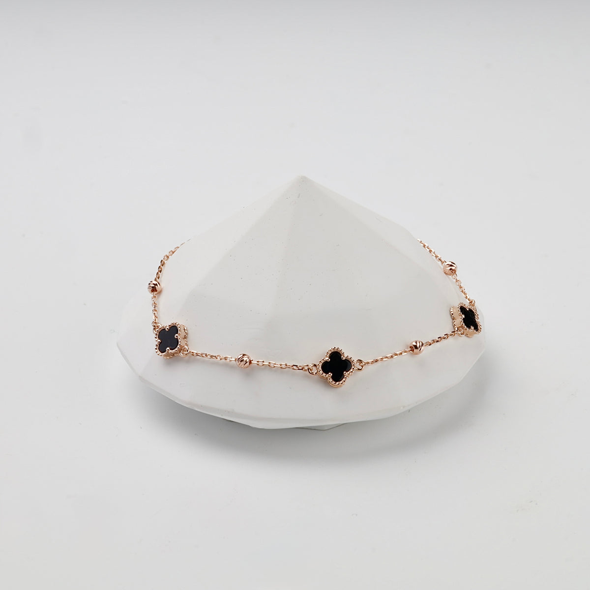 Rose gold 585 black onyx clover bracelet, styled front view