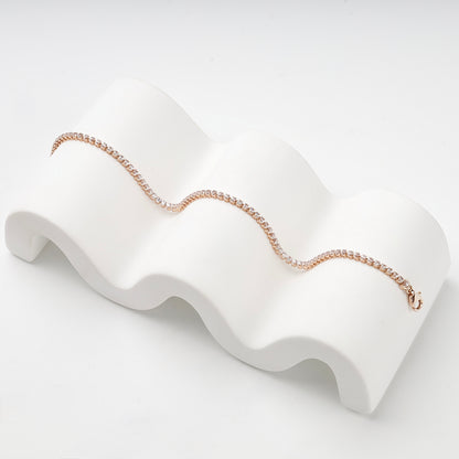 Rose gold tennis bracelet displayed in a flowing line