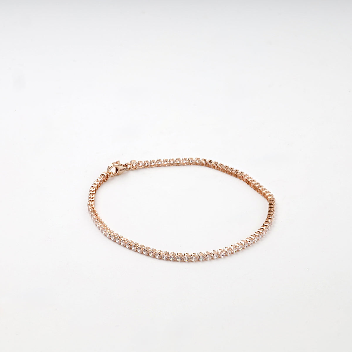Rose gold tennis bracelet open-backed settings detail
