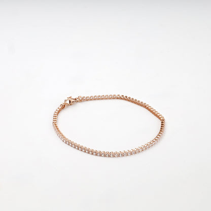 Rose gold tennis bracelet open-backed settings detail
