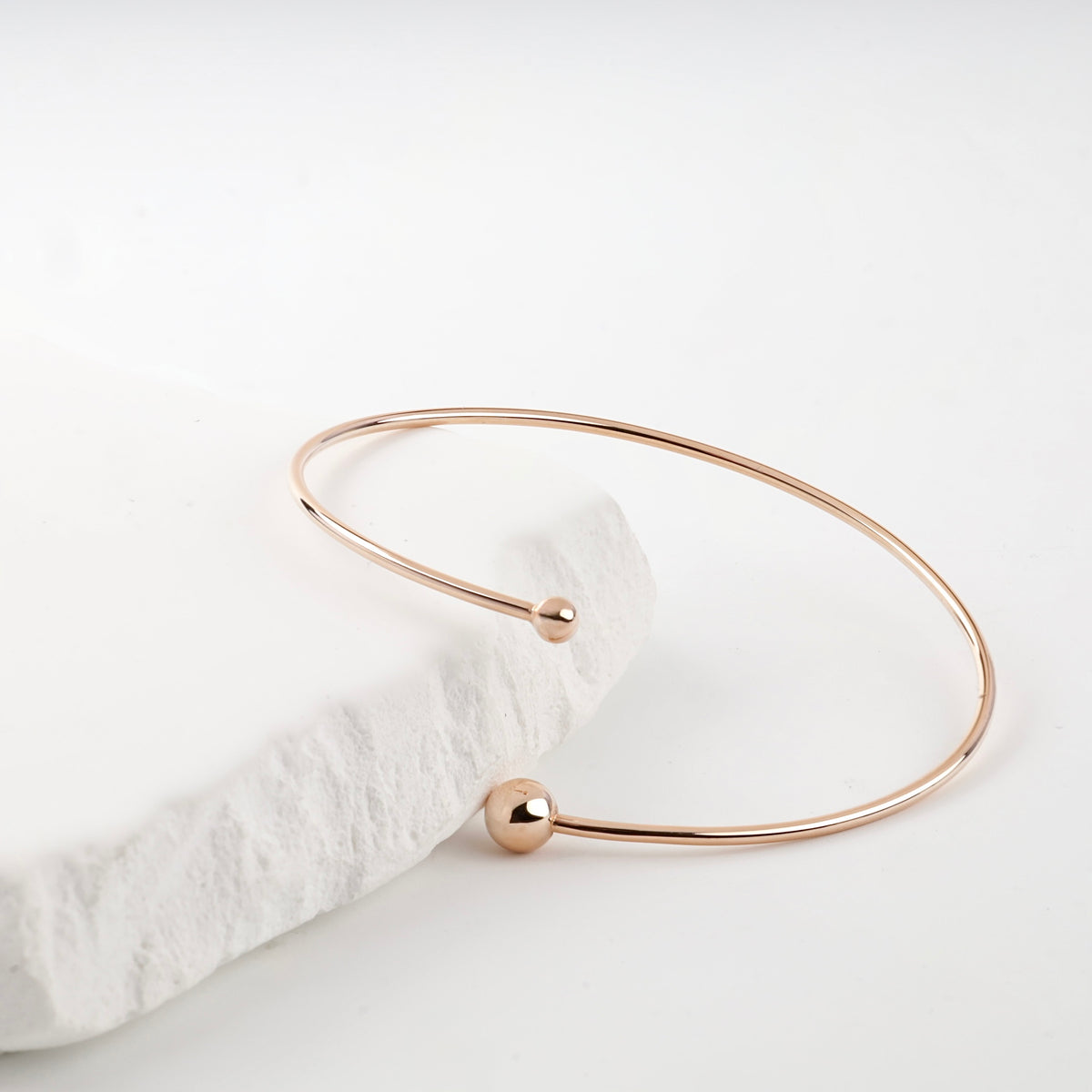 Rose gold bangle bracelet larger ball detail measured by caliper