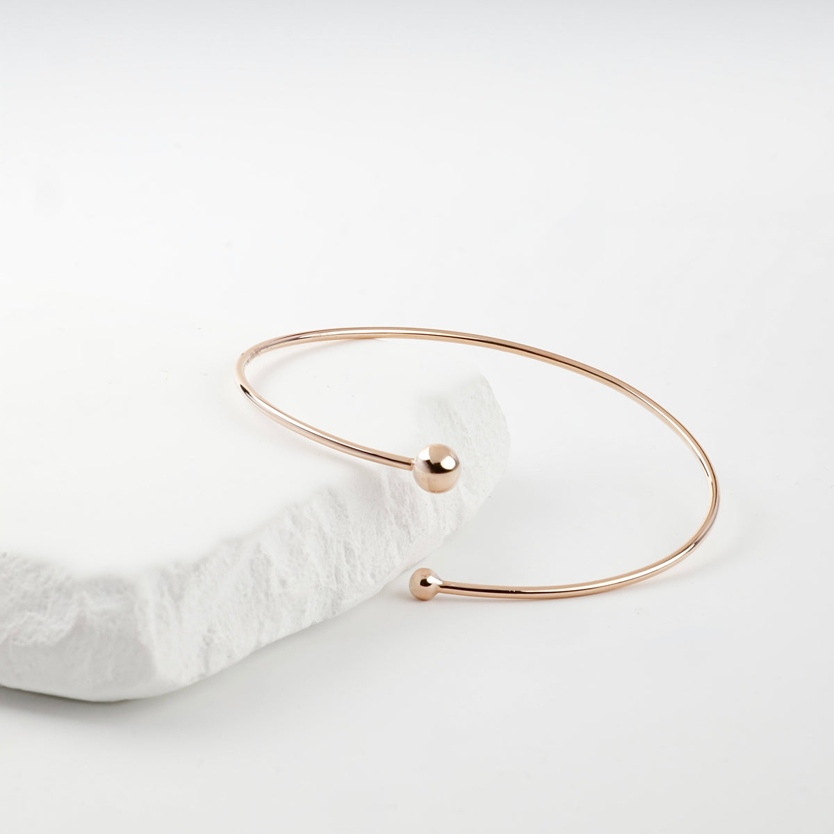 Rose gold open bracelet smaller ball detail measured by caliper