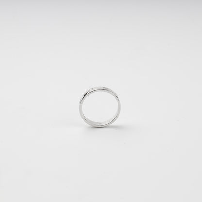 Close-up of engraved screw motifs around the polished silver ring