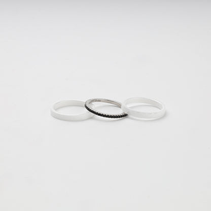 Three separate white ceramic and Silver 925 rings with black cubic zirconia