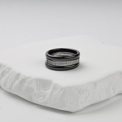 Three-ring set with glossy black ceramic bands and a double row of clear cubic zirconia