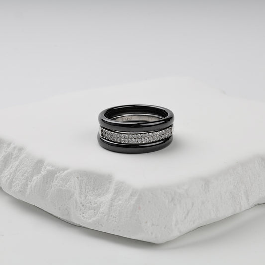 Three-ring set with glossy black ceramic bands and a double row of clear cubic zirconia