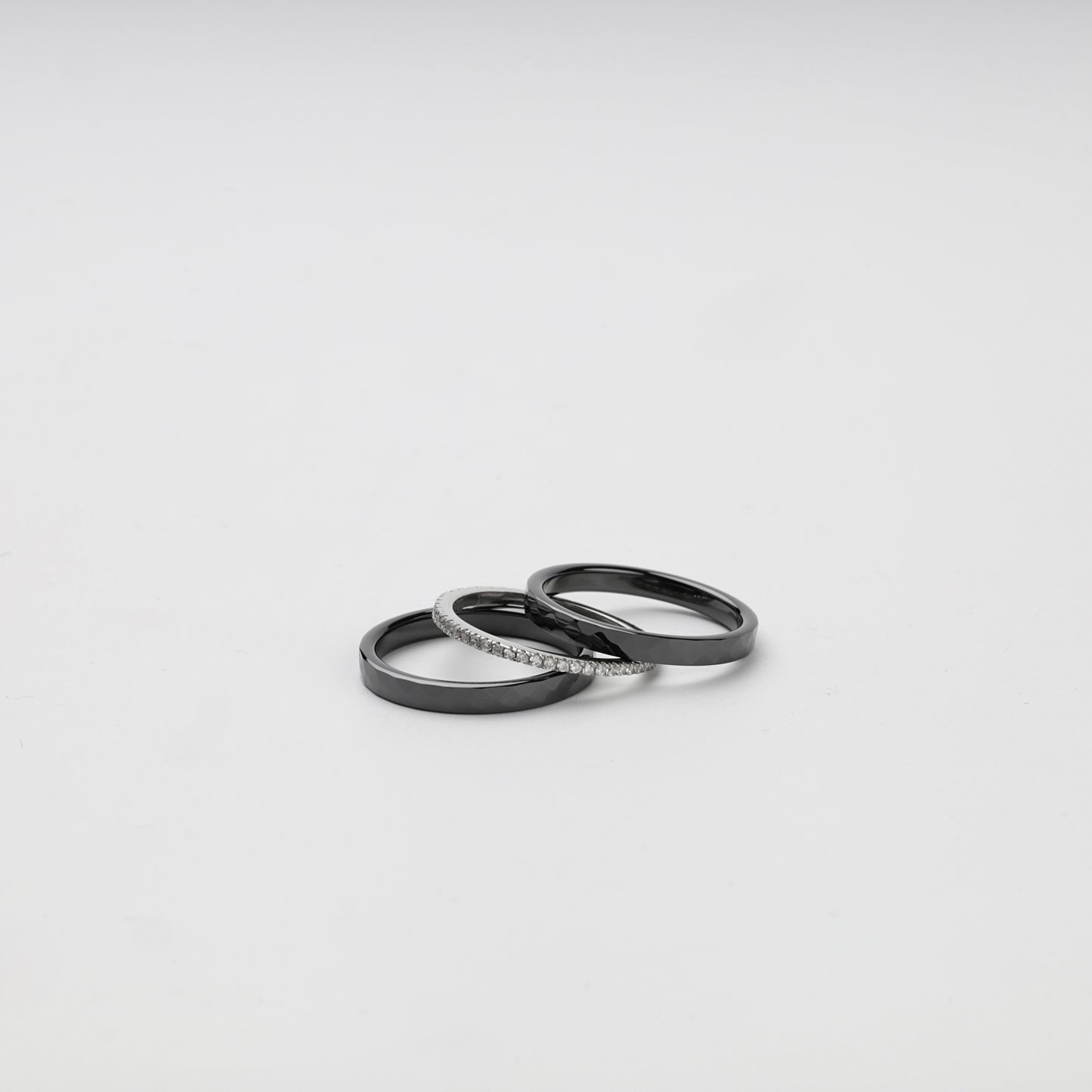 Black ceramic ring set arranged with the clear cubic zirconia band in front