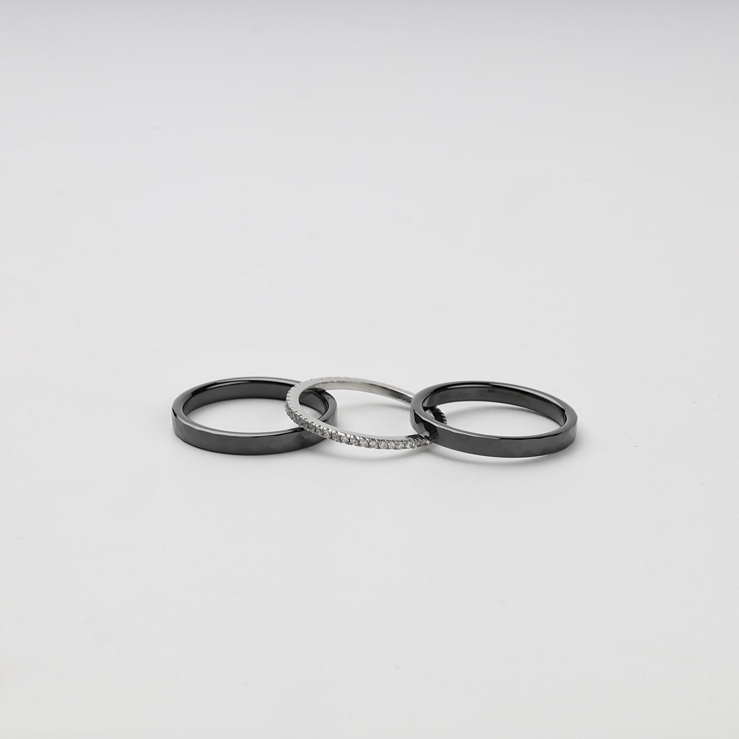 Three separate faceted black ceramic and Silver 925 cubic zirconia rings