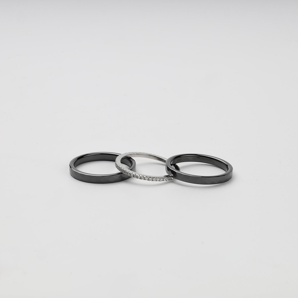 Three separate faceted black ceramic and Silver 925 cubic zirconia rings