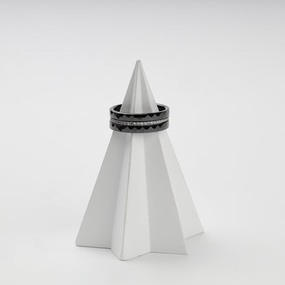 Faceted black ceramic rings stacked around a clear cubic zirconia center row
