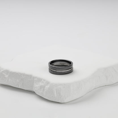 Faceted black ceramic three-ring set with a single row of clear cubic zirconia