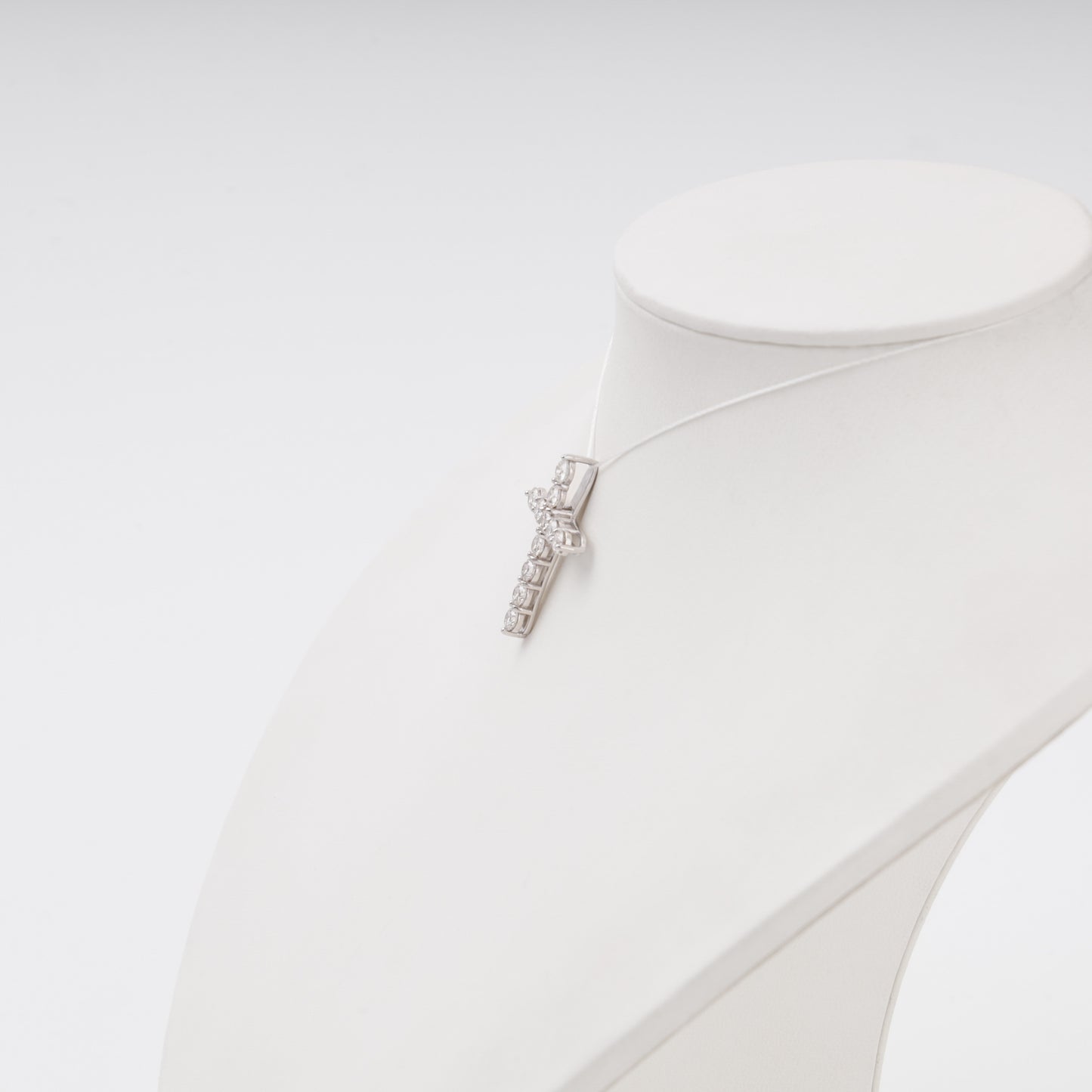 Diamond cross pendant side profile on bust display - Kabluchka