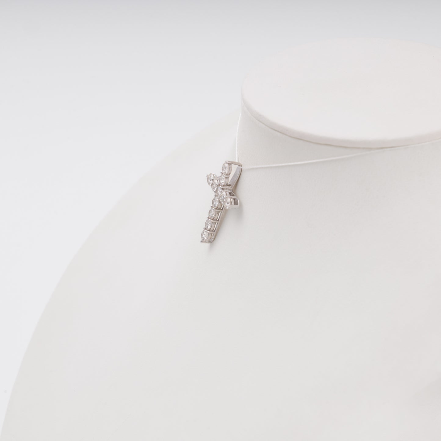 Diamond cross pendant side angle on bust display - Kabluchka jewelry