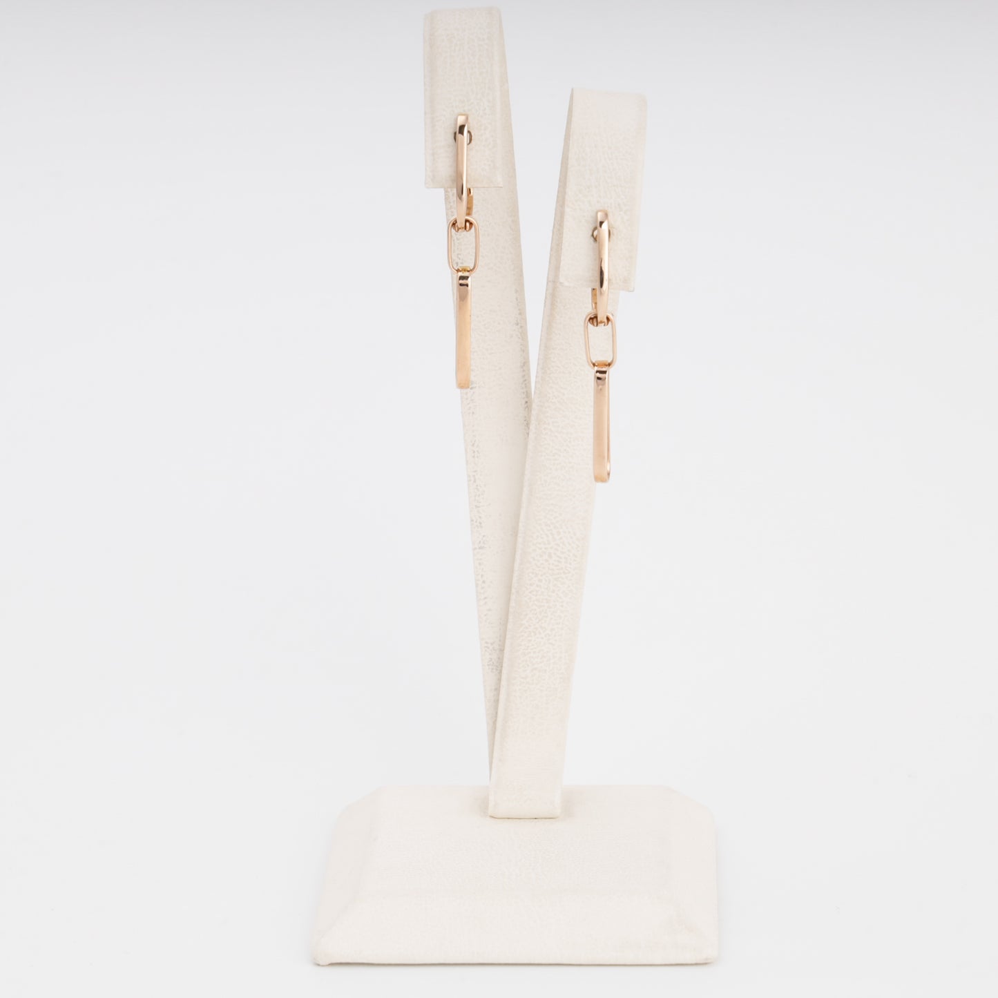 14k gold bar drop earrings on a cream display stand, minimalist dangle earrings, Ukrainian Jewelry for everyday wear.