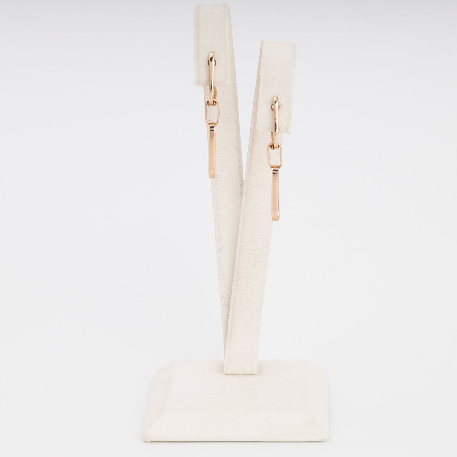 14k gold bar drop earrings on a cream display stand, minimalist dangle earrings, Ukrainian Jewelry for everyday wear.