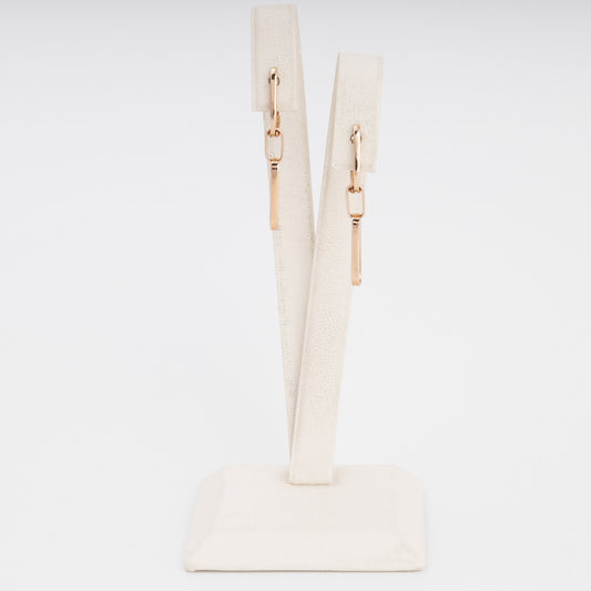 14k gold bar drop earrings on a cream display stand, minimalist dangle earrings, Ukrainian Jewelry for everyday wear.
